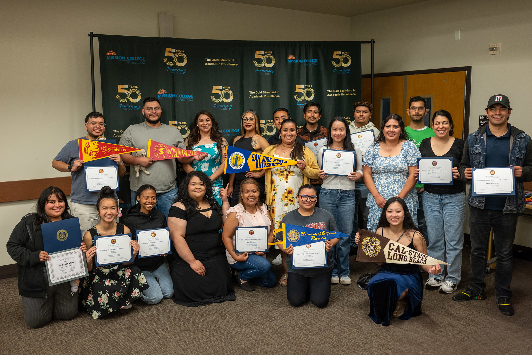 Mission College students holding college transfer flags