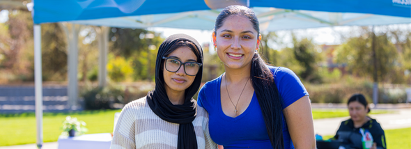 Two students smiling