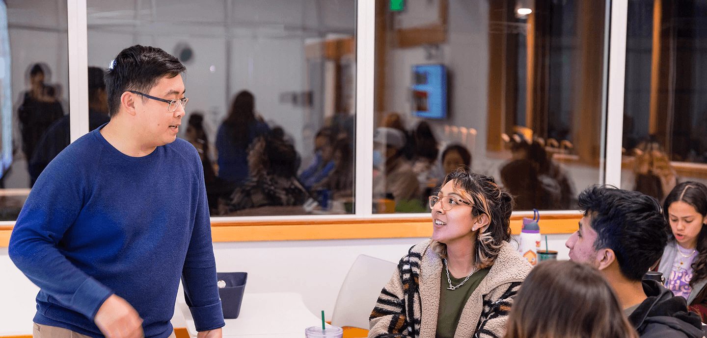 Faculty member talking to students