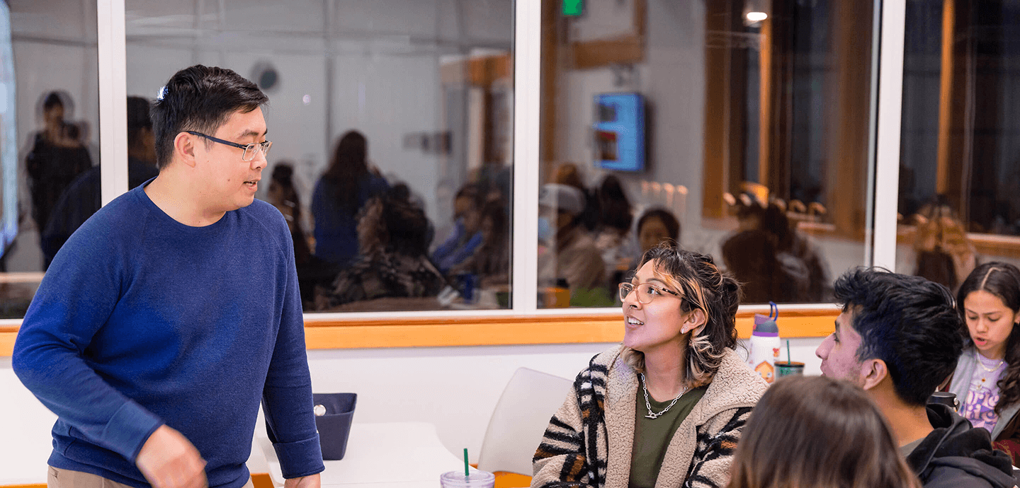 Faculty member talking to students
